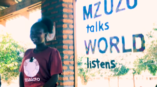 Young lady smiling and giving a speech.