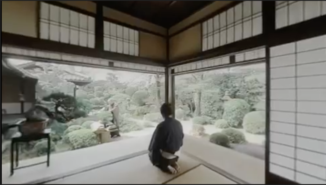 A person kneeling before the atomic tree